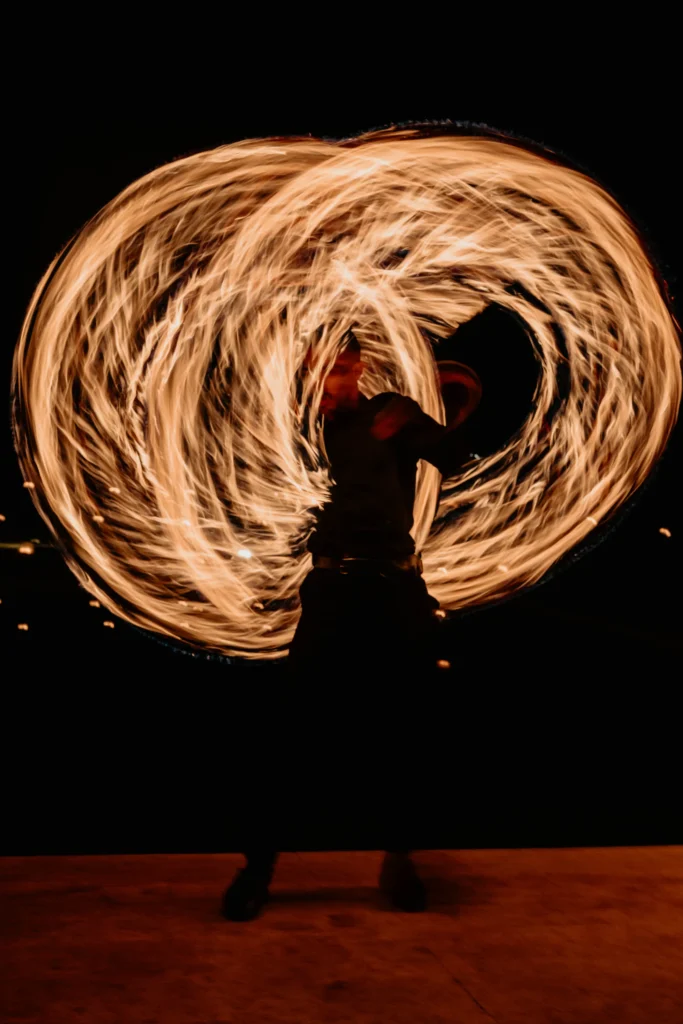 Fire dancer performing at a Marrakesh wedding reception at night, Morocco destination wedding entertainment