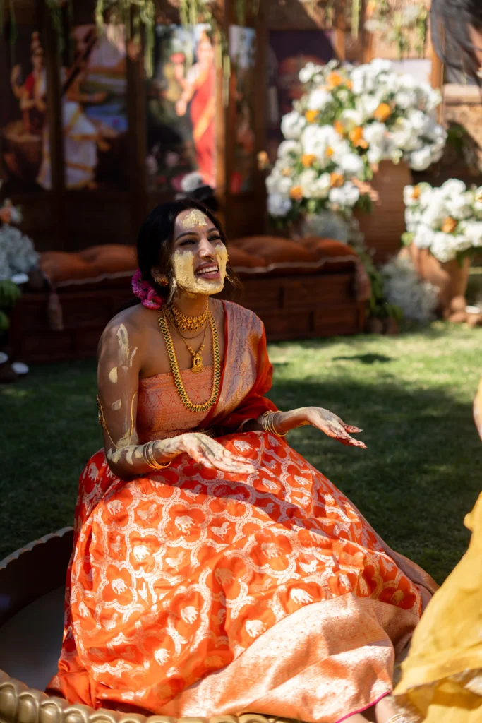 Indian bride in orange lehenga during her haldi ceremony at a Marrakesh destination wedding in Morocco