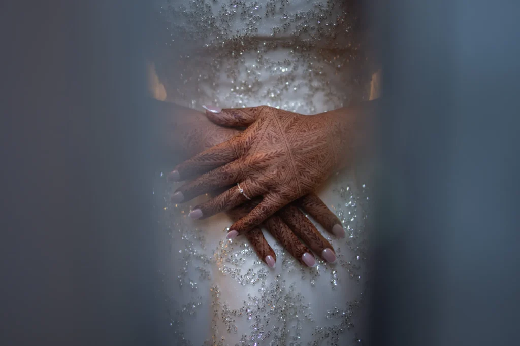 Close-up of a couple's hands intertwined, intimate Morocco destination wedding detail photography