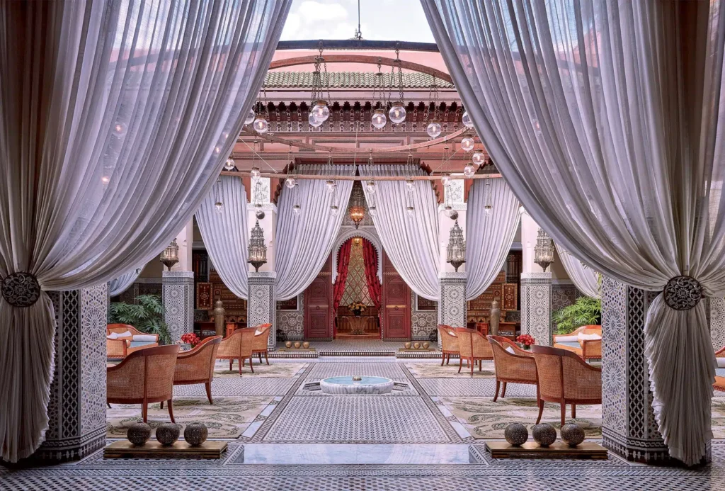 Royal Mansour riad courtyard with white drapes and Moorish arches, luxury Marrakech wedding venue