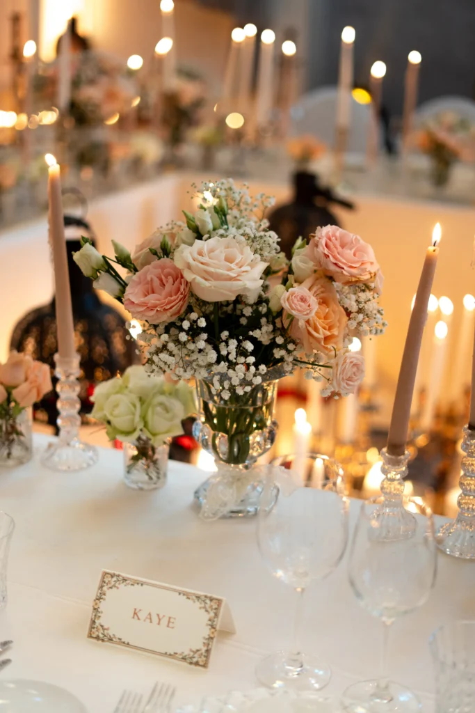 Candlelit reception tablescape with roses and place cards, luxury Marrakesh destination wedding