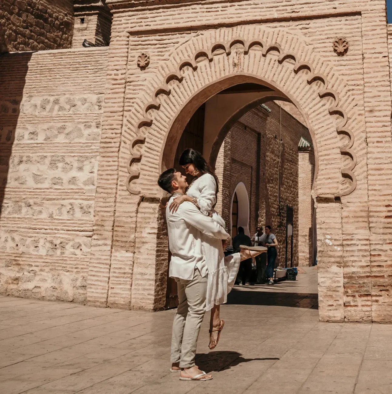 Bride and groom on Essaouira beach after their Morocco destination wedding